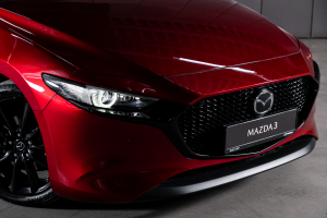 Front passenger side of a red Mazda