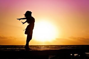 Woman's silhouette on beach during sunset